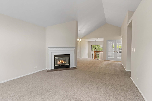 1623 Camberley Ct, Bartlett, IL 60103 - unfurnished living room featuring carpet floors, lofted ceiling, a fireplace with flush hearth, baseboards, and french doors