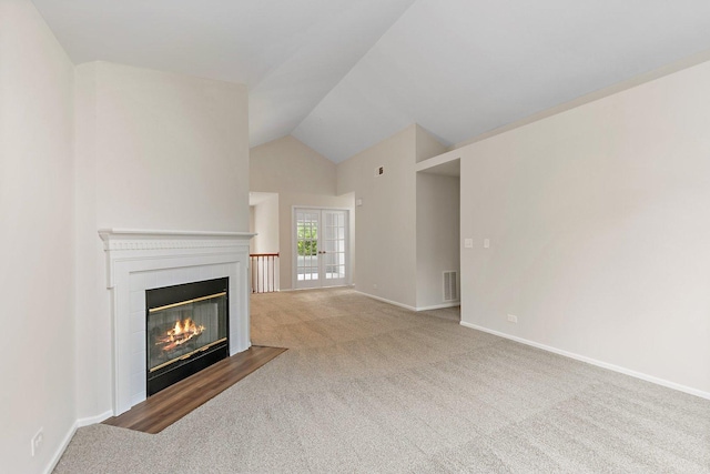1623 Camberley Ct, Bartlett, IL 60103 - unfurnished living room with a glass covered fireplace, carpet, baseboards, and lofted ceiling