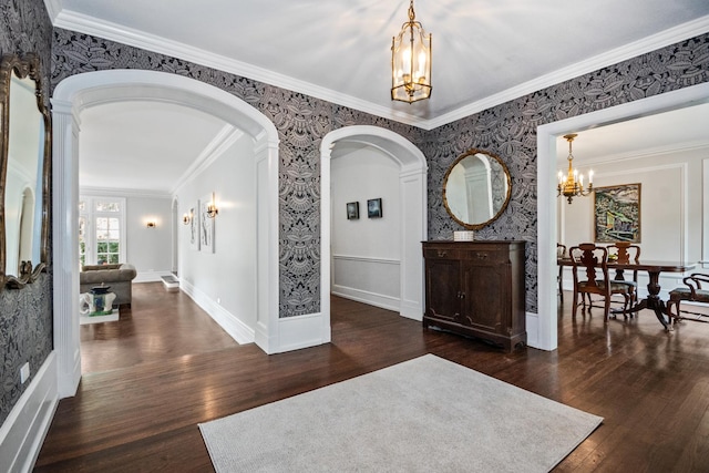 2906 Lincoln St, Evanston, IL 60201 - foyer with a chandelier, arched walkways, wood finished floors, wallpapered walls, and ornamental molding