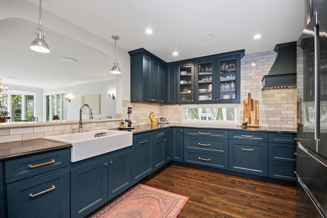 2906 Lincoln St, Evanston, IL 60201 - kitchen featuring wall chimney exhaust hood, blue cabinets, a sink, decorative backsplash, and dark wood-style floors