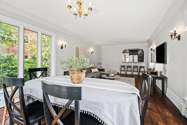 2906 Lincoln St, Evanston, IL 60201 - dining space featuring dark wood finished floors, crown molding, a chandelier, and baseboards