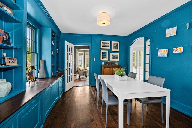 2906 Lincoln St, Evanston, IL 60201 - dining room featuring arched walkways, crown molding, french doors, dark wood-style floors, and baseboards