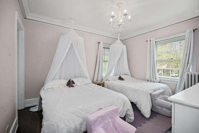 2906 Lincoln St, Evanston, IL 60201 - bedroom featuring a chandelier, radiator heating unit, multiple windows, crown molding, and baseboards