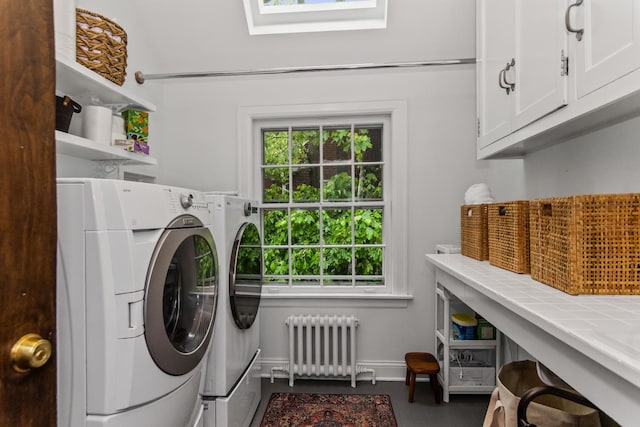 2906 Lincoln St, Evanston, IL 60201 - laundry area featuring radiator, cabinet space, washer and dryer, baseboards, and a skylight