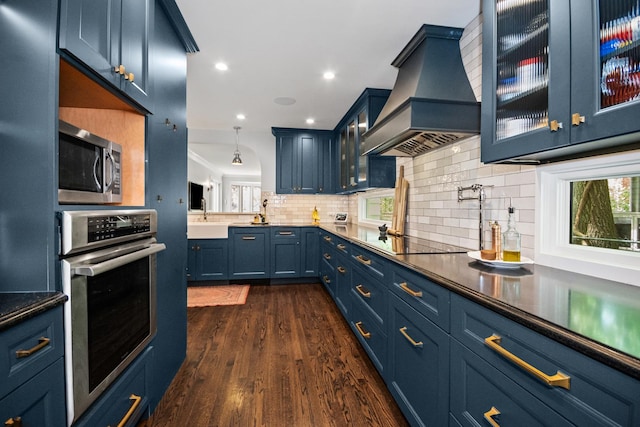 2906 Lincoln St, Evanston, IL 60201 - kitchen with appliances with stainless steel finishes, custom exhaust hood, a sink, backsplash, and glass insert cabinets