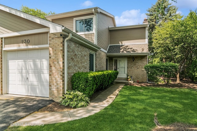 230 W Golfview Ter, Palatine, IL 60067 - mid-century inspired home featuring a chimney, a front lawn, asphalt driveway, a garage, and brick siding