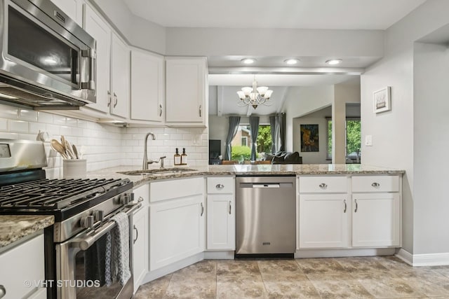 230 W Golfview Ter, Palatine, IL 60067 - kitchen featuring appliances with stainless steel finishes, a chandelier, backsplash, and light stone countertops