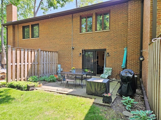 1830 Chestnut Ave Unit 1830, Glenview, IL 60025 - back of property with a patio area, brick siding, and a chimney
