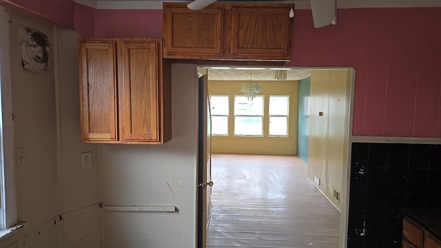316 E 107th St, Chicago, IL 60628 - kitchen with brown cabinetry and light wood-style flooring