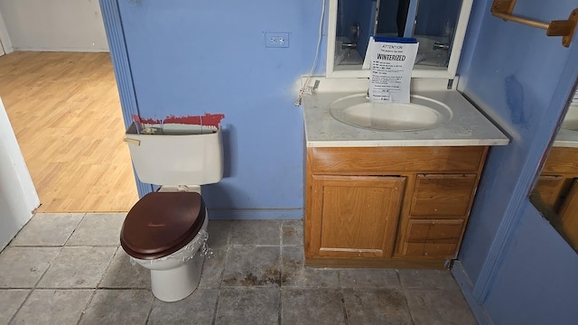316 E 107th St, Chicago, IL 60628 - bathroom with toilet, vanity, and baseboards