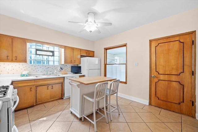 6141 W Peterson Ave, Chicago, IL 60646 - kitchen with white appliances, a sink, light countertops, decorative backsplash, and light tile patterned flooring