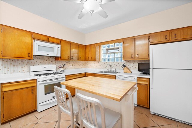6141 W Peterson Ave, Chicago, IL 60646 - kitchen featuring white appliances, a sink, tasteful backsplash, light tile patterned floors, and ceiling fan