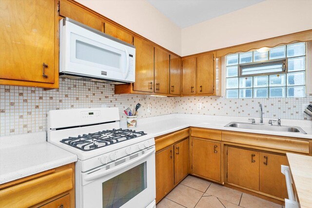 6141 W Peterson Ave, Chicago, IL 60646 - kitchen with white appliances, a sink, light countertops, backsplash, and light tile patterned floors
