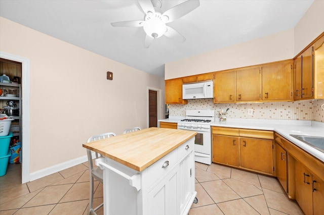 6141 W Peterson Ave, Chicago, IL 60646 - kitchen with white appliances, light tile patterned floors, decorative backsplash, ceiling fan, and a kitchen bar