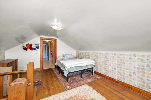 6141 W Peterson Ave, Chicago, IL 60646 - bedroom featuring wood finished floors, baseboards, and lofted ceiling