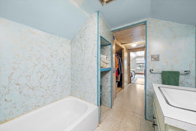 6141 W Peterson Ave, Chicago, IL 60646 - full bath featuring lofted ceiling, vanity, a tub to relax in, and a spacious closet
