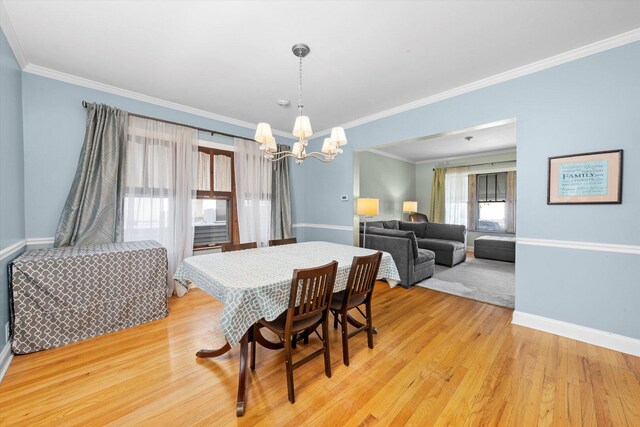 6141 W Peterson Ave, Chicago, IL 60646 - dining area with a chandelier, baseboards, crown molding, and light wood finished floors