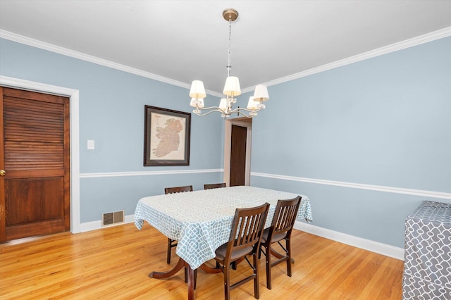 6141 W Peterson Ave, Chicago, IL 60646 - dining area with a chandelier, baseboards, light wood-style flooring, and ornamental molding