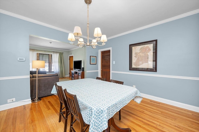 6141 W Peterson Ave, Chicago, IL 60646 - dining room with a chandelier, baseboards, light wood finished floors, and ornamental molding