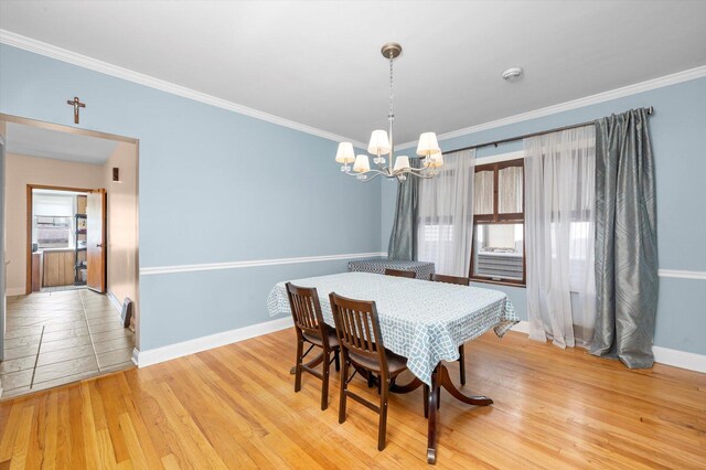 6141 W Peterson Ave, Chicago, IL 60646 - dining space with baseboards, a chandelier, light wood-type flooring, and ornamental molding
