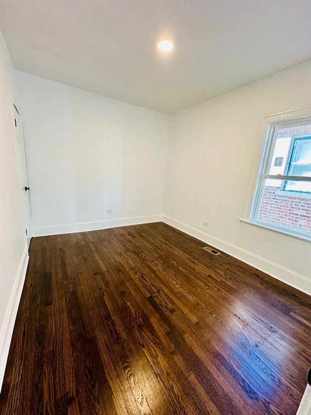 8344 S Ada St, Chicago, IL 60620 - spare room featuring dark wood-type flooring and baseboards