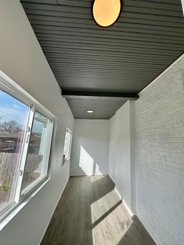 8344 S Ada St, Chicago, IL 60620 - hallway featuring brick wall, baseboards, and wood finished floors
