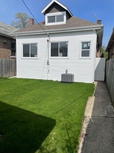 8344 S Ada St, Chicago, IL 60620 - back of house with cooling unit, a chimney, and a shingled roof