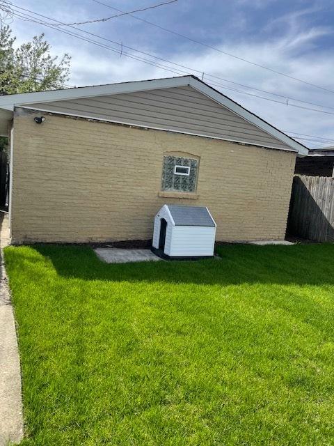 8344 S Ada St, Chicago, IL 60620 - view of side of home with brick siding and a storage shed