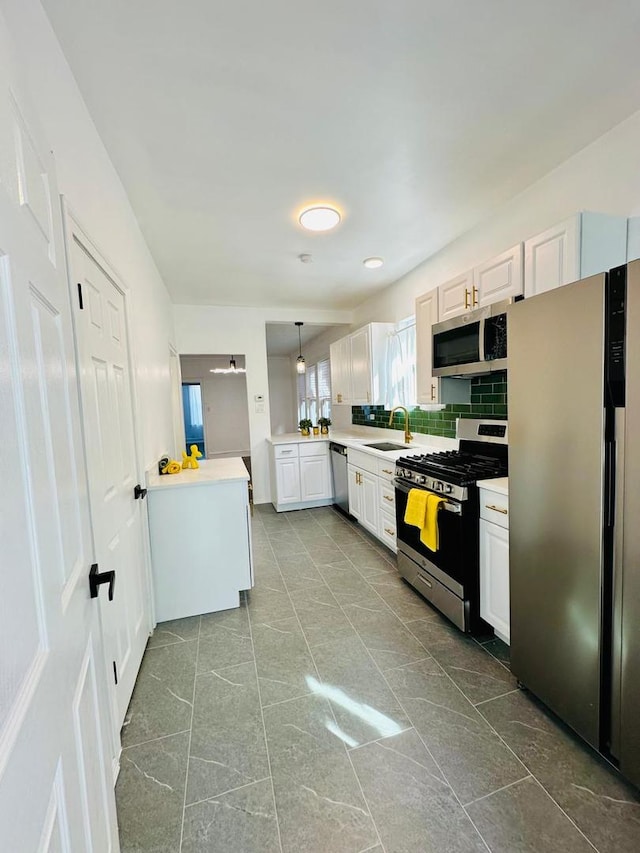 8344 S Ada St, Chicago, IL 60620 - kitchen with stainless steel appliances, light countertops, a peninsula, and tasteful backsplash