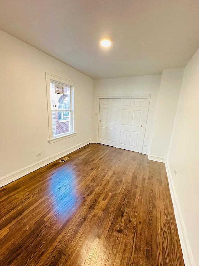 8344 S Ada St, Chicago, IL 60620 - unfurnished bedroom featuring dark wood finished floors, baseboards, and a closet