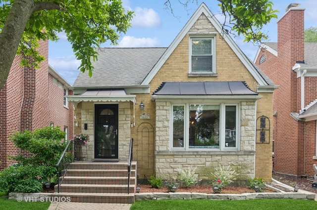 6209 N Legett Ave, Chicago, IL 60646 - tudor house with stone siding, a standing seam roof, a metal roof, and a shingled roof