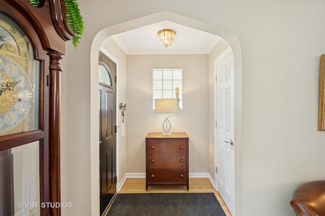 6209 N Legett Ave, Chicago, IL 60646 - foyer featuring arched walkways, wood finished floors, and crown molding