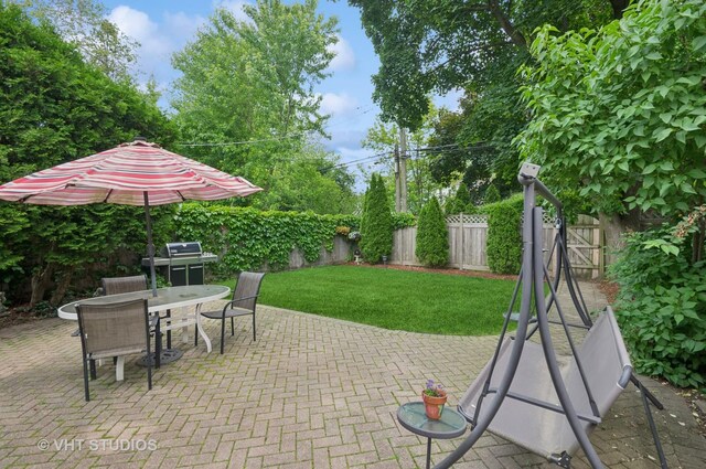 6209 N Legett Ave, Chicago, IL 60646 - fenced backyard featuring a patio area, a grill, and outdoor dining space