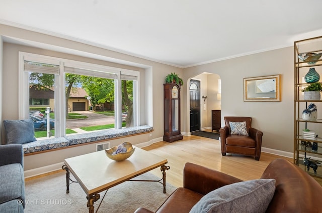 6209 N Legett Ave, Chicago, IL 60646 - living room featuring arched walkways, crown molding, and light wood-type flooring