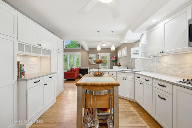6209 N Legett Ave, Chicago, IL 60646 - kitchen featuring white cabinetry, backsplash, light countertops, light wood-type flooring, and recessed lighting