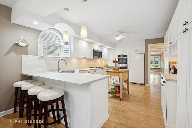 6209 N Legett Ave, Chicago, IL 60646 - kitchen with stainless steel appliances, tasteful backsplash, light countertops, light wood-style floors, and recessed lighting
