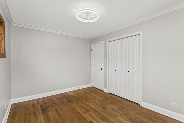 521 N 3rd Ave, Villa Park, IL 60181 - unfurnished bedroom with wood finished floors, baseboards, ornamental molding, and a closet