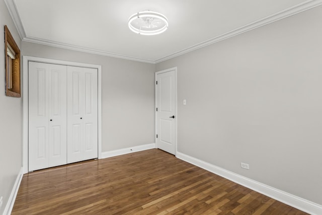 521 N 3rd Ave, Villa Park, IL 60181 - unfurnished bedroom with wood finished floors, baseboards, crown molding, and a closet