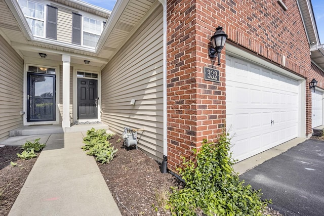 332 Buckingham Ct, Lombard, IL 60148 - entrance to property with a garage, brick siding, and asphalt driveway