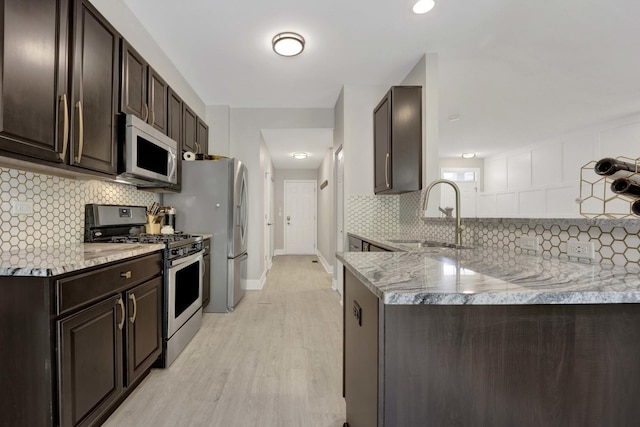 332 Buckingham Ct, Lombard, IL 60148 - kitchen with stainless steel appliances, dark brown cabinets, light wood-style floors, and decorative backsplash