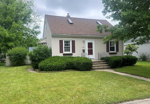826 N 11th St, Rochelle, IL 61068 - cape cod house featuring a front yard, a chimney, and roof with shingles