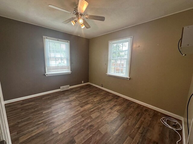 826 N 11th St, Rochelle, IL 61068 - spare room featuring dark wood-type flooring, a ceiling fan, and baseboards