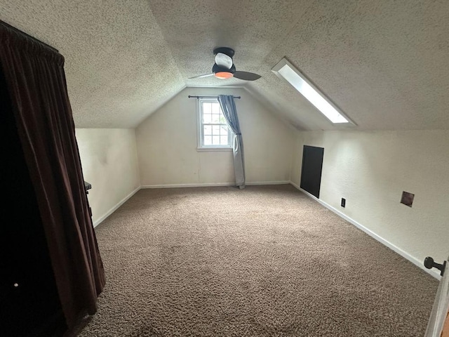 826 N 11th St, Rochelle, IL 61068 - bonus room with a skylight, carpet, vaulted ceiling, a textured ceiling, and baseboards