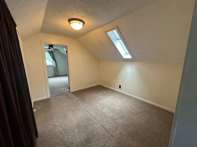 826 N 11th St, Rochelle, IL 61068 - bonus room with carpet, lofted ceiling, a skylight, a textured ceiling, and baseboards