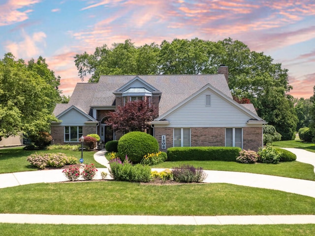 1806 Bentbrook Dr, Champaign, IL 61822 - view of front facade with brick siding, a front lawn, and a chimney