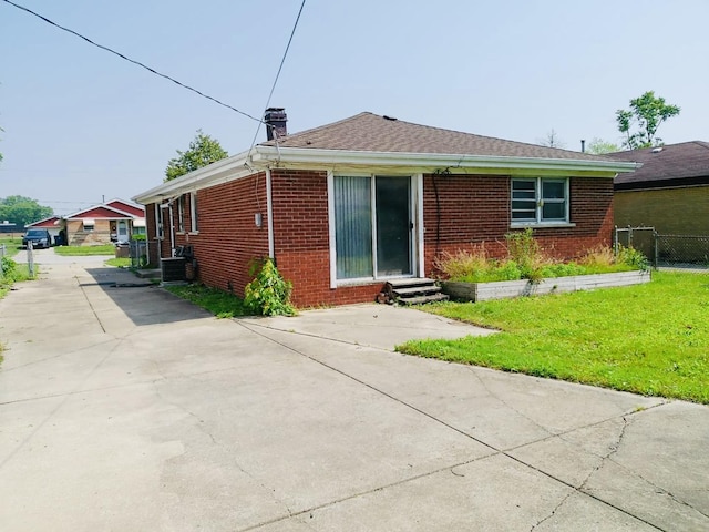 3923 153rd St, Midlothian, IL 60445 - rear view of house with brick siding, entry steps, a chimney, and driveway