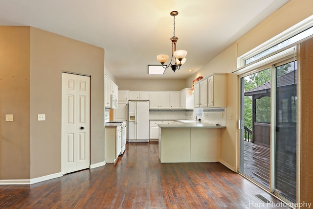 996 Highgate Ln, Grayslake, IL 60030 - kitchen with white appliances, a peninsula, a chandelier, dark wood-type flooring, and hanging light fixtures