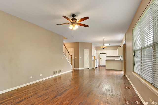 996 Highgate Ln, Grayslake, IL 60030 - unfurnished living room featuring dark wood-style floors, ceiling fan, stairs, and a chandelier