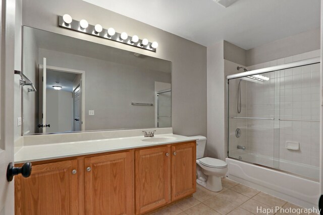 996 Highgate Ln, Grayslake, IL 60030 - bathroom featuring tile patterned floors, vanity, and combined bath / shower with glass door