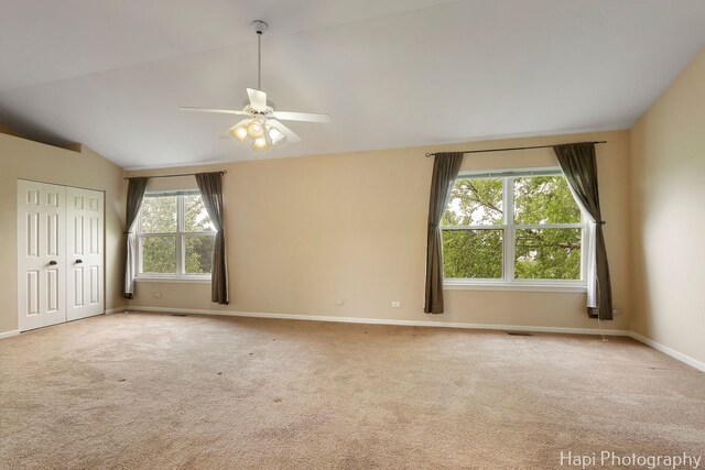 996 Highgate Ln, Grayslake, IL 60030 - unfurnished bedroom with lofted ceiling, carpet flooring, a ceiling fan, and a closet